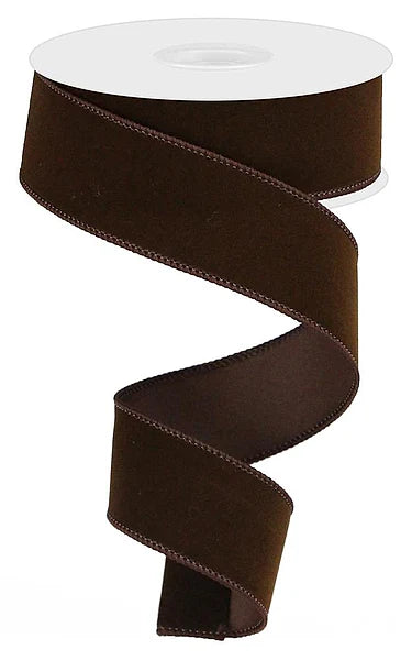 Chocolate brown indoor velvet ribbon, 1.5 inches wide by 10 yards long, displayed on a white spool with soft velvet texture and decorative stitched edges.