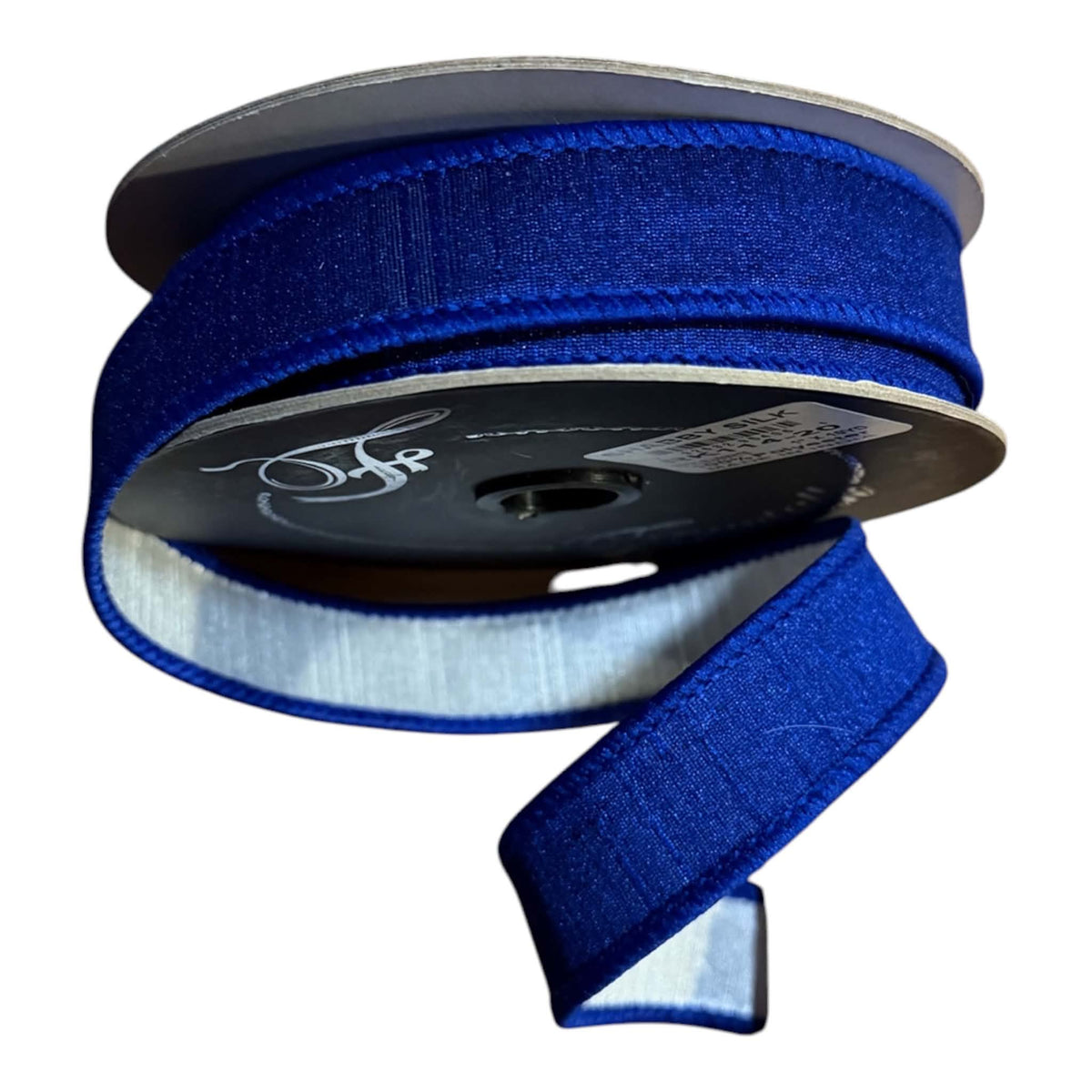 Farrisilk 1-inch x 10-yard royal blue designer ribbon on a black spool, featuring a fine vertically ribbed blue face with coordinating blue stitched edges and a smooth white satin reverse visible on the loose tail
