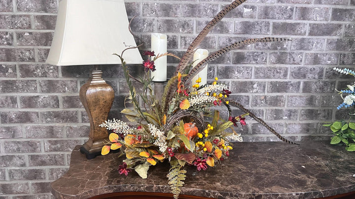 Eclectic “One of a Kind” Fall Grapevine Stand arrangement. Fuzzy Orange Jute wrapped stem pumpkins with golden berries with Pheasant Feather