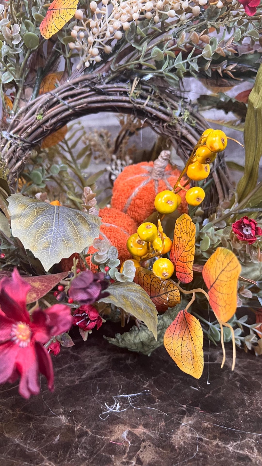 Eclectic “One of a Kind” Fall Grapevine Stand arrangement. Fuzzy Orange Jute wrapped stem pumpkins with golden berries with Pheasant Feather