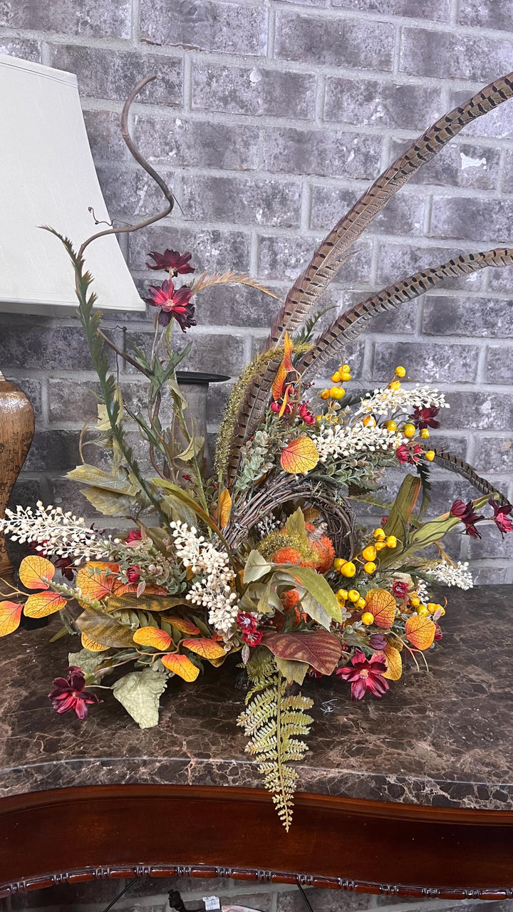 Eclectic “One of a Kind” Fall Grapevine Stand arrangement. Fuzzy Orange Jute wrapped stem pumpkins with golden berries with Pheasant Feather