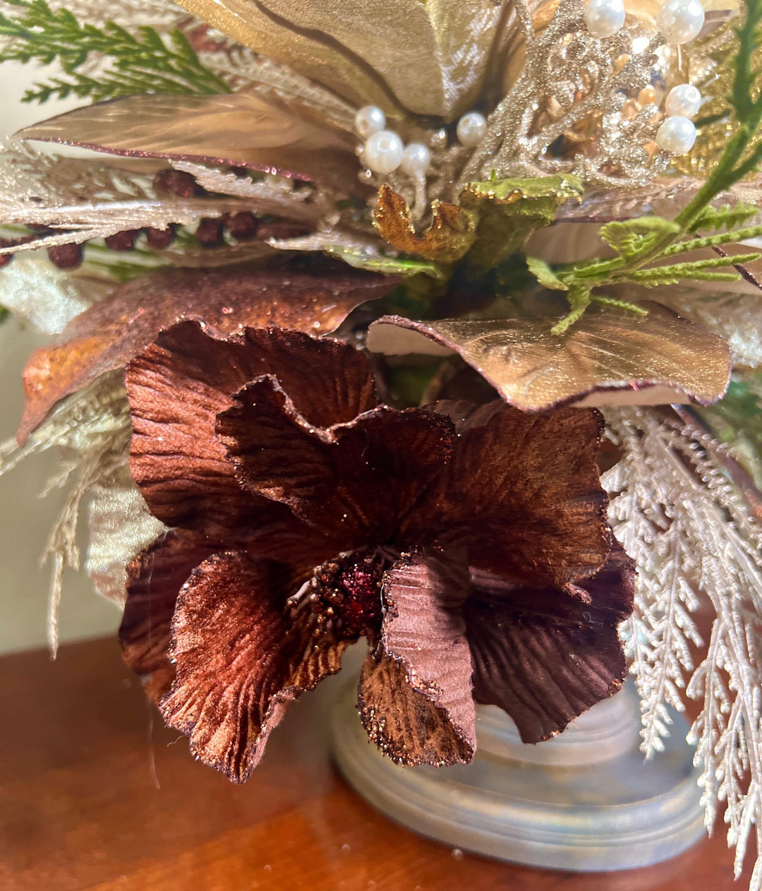 Unique Oranament arrangement with designer magnolias stacked on a wooden disc - Designer netting ribbon