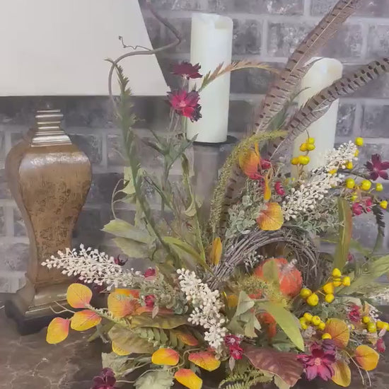 Eclectic “One of a Kind” Fall Grapevine Stand arrangement. Fuzzy Orange Jute wrapped stem pumpkins with golden berries with Pheasant Feather